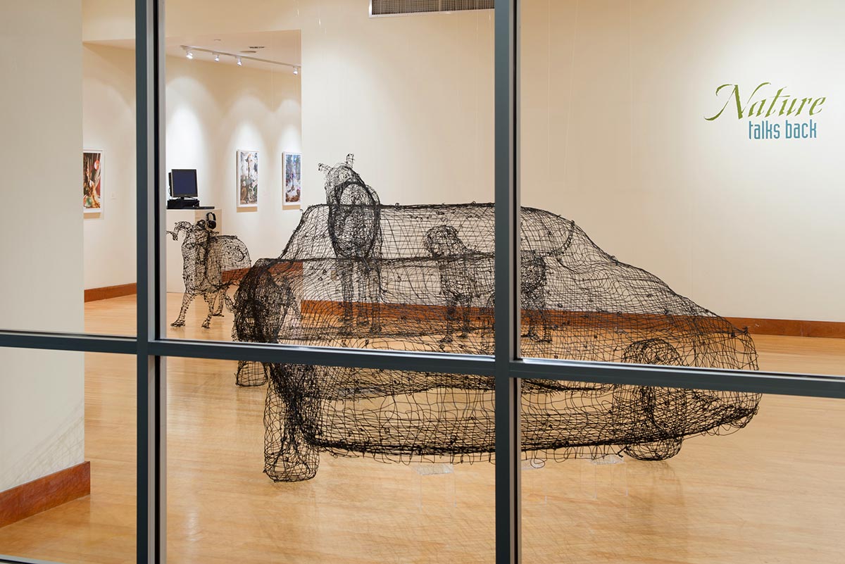 Gallery view of the rear of the 1969 Dodge Charger with a group of wire animals in front of it